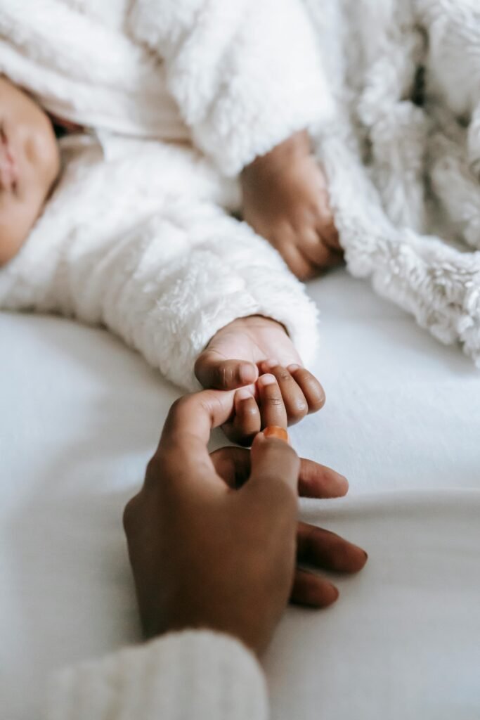 avoid sleep regression by reassuring your baby gently hold babys hand until they are asleep